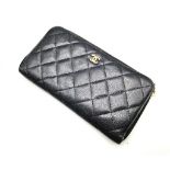 A Chanel Clutch Bag/Wallet. Soft quilted black leather. Gilded Chanel exterior logo. Burgundy