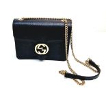 A Gucci Interlocking Black Leather Small Shoulder Bag. Pebbled calfskin with gilded hardware.