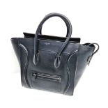 A Celine of Paris Micro Luggage Handbag in Black Leather. Zipped exterior and interior pockets.