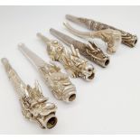 A very collectible group of six antique, Chinese silver dragon smoking pipes, presented in a