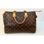 A Louis Vuitton Monogram Ladies Speedy Bag. Brown LV canvas with brown leather handles and gold-tone