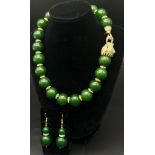 An excellent quality, large beaded green jade necklace and earrings set with a large panther clasp
