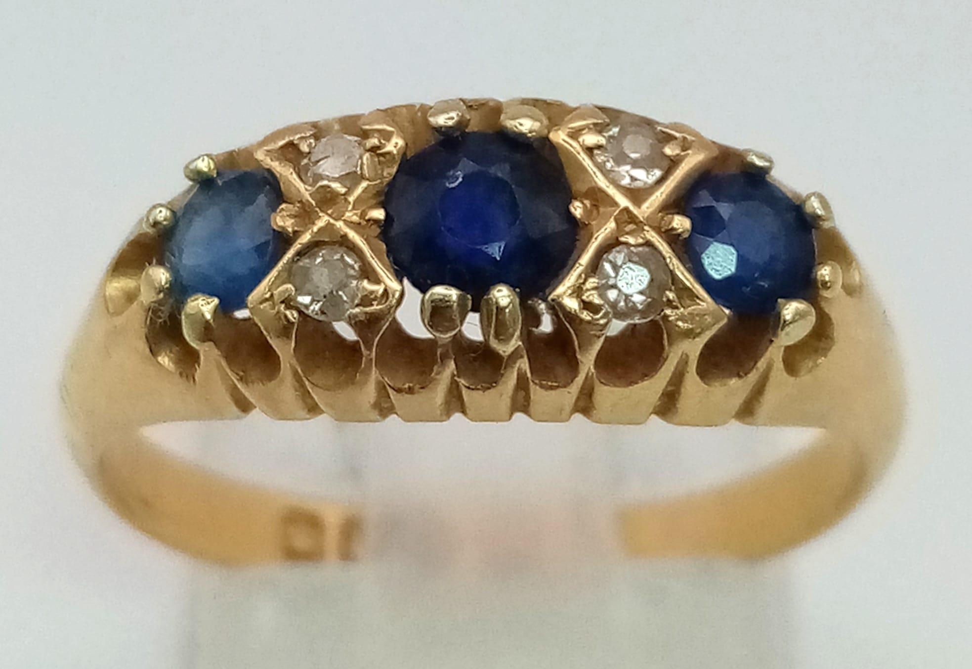 An antique, 18 K yellow gold ring with old cut diamonds and sapphires (0.65 carats). Hallmarked