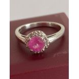 Stunning RUBY and SILVER RING having a circular cushion cut RUBY mounted to top with Diamond