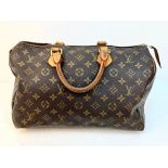 A Louis Vuitton Monogram Speedy Canvas Bag. Gold-tone hardware. Leather trim and handles. Brown