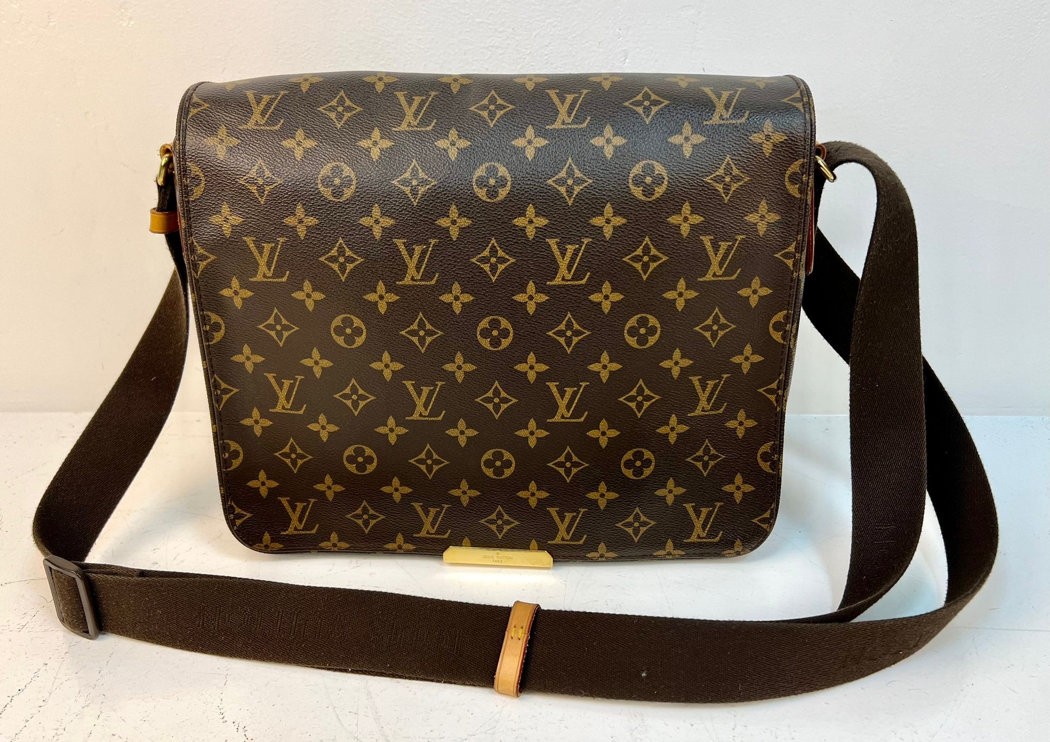 A Louis Vuitton Large Flap Shoulder Bag and Dust Cover. LV monogram canvas. Gold-tone hardware.