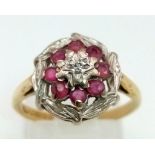 An 18 K yellow gold ring with a cluster of diamonds and rubies. Ring size: N, weight: 3.3 g.