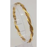 A Vintage 18K Yellow Gold Twist Bangle. An overlapping wave design creates a stylish piece. 6.5cm