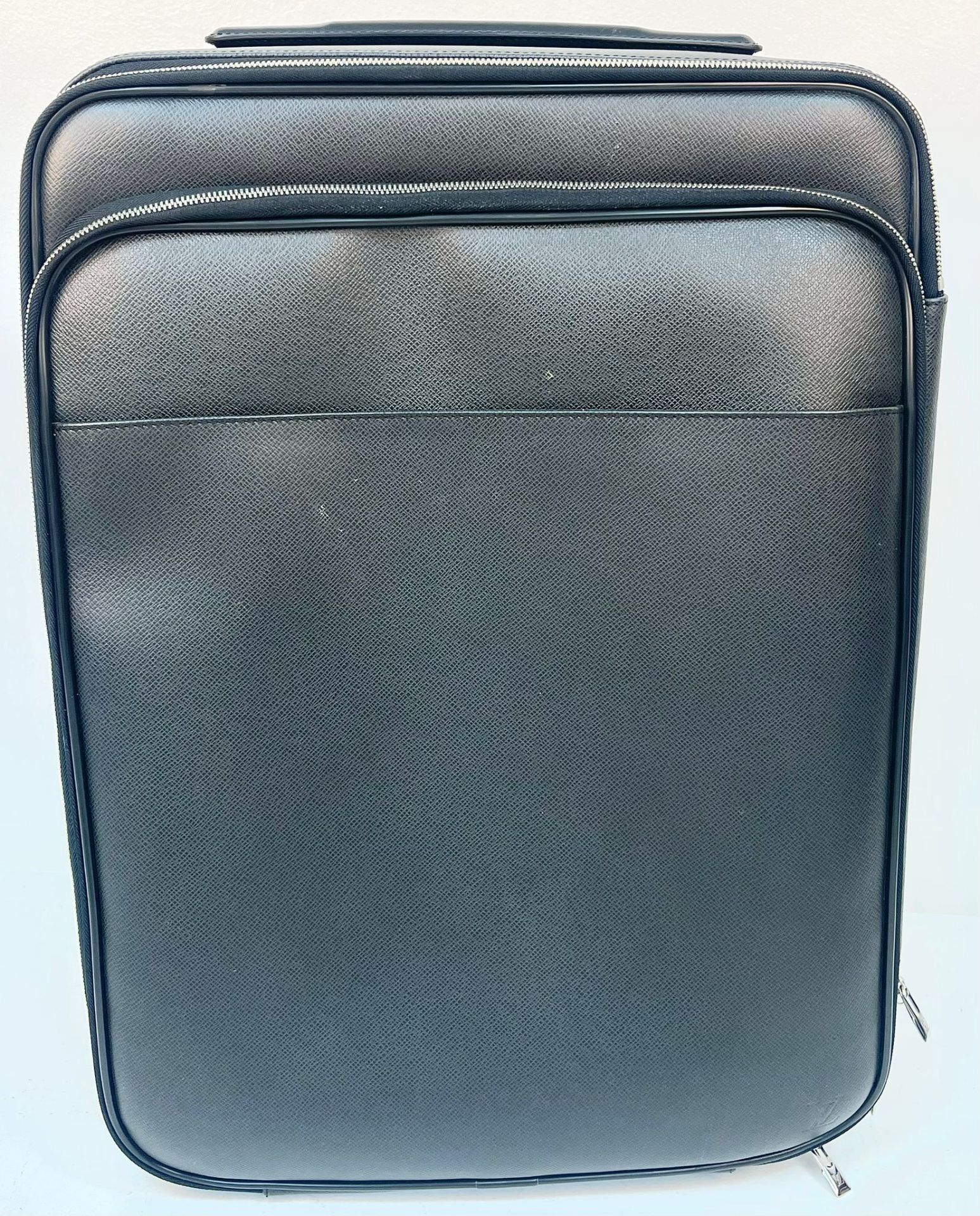 A Louis Vuitton Pegase Taiga Leather Suitcase. Extendable trolley-pull handle. Twin wheels. Black