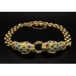 A wonderful 18 K yellow gold designer style PANTHER bracelet with emeralds and diamonds and ruby