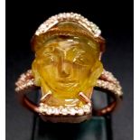 A 14K Rose Gold 9.6ct Tourmaline Ring in the Carved Shape of a Buddha. Size L. Comes with an AIG