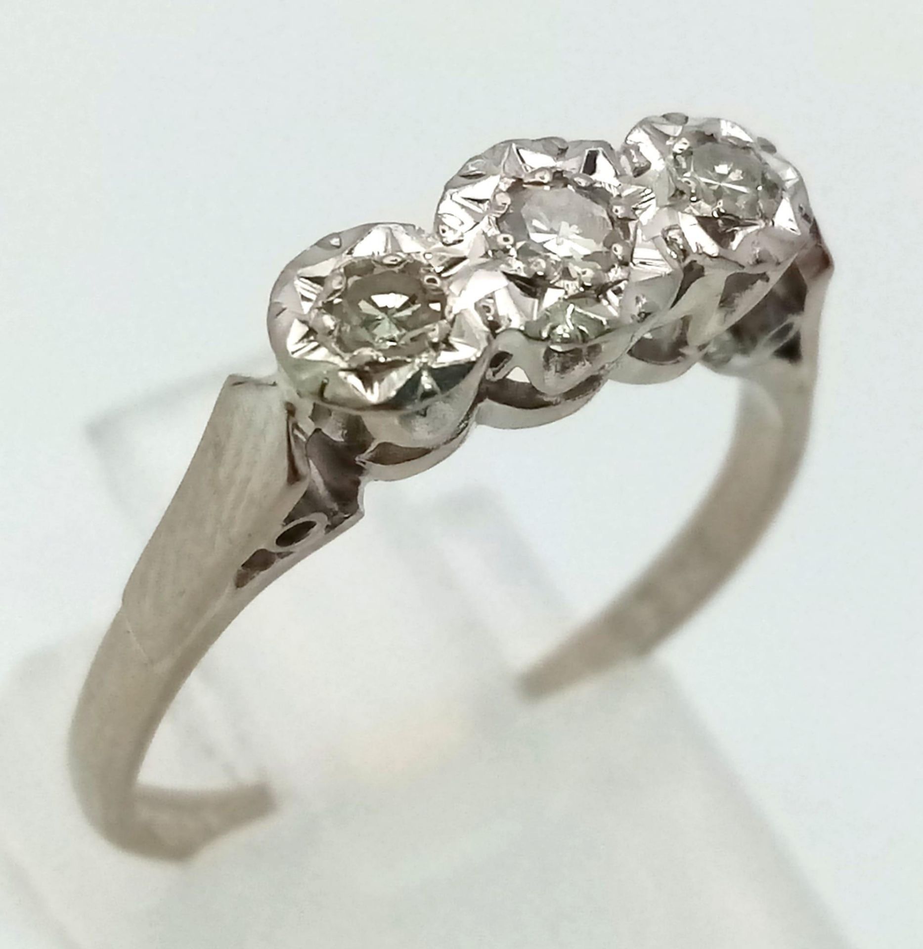 An 18K White Gold Three Stone Diamond Ring. Size N. 3.05g total weight. - Image 2 of 4