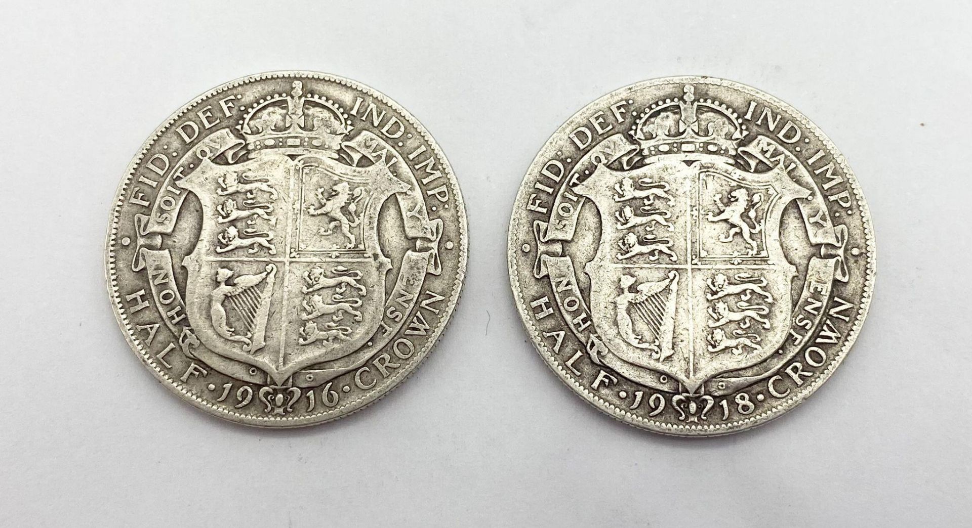 A British 1916 and a 1918 Silver Half Crown Coin. Please see photos for conditions.