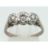 An 18K White Gold Three Stone Diamond Ring. Size N. 3.05g total weight.
