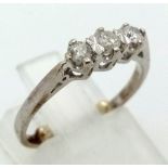 A 9K White Gold Three-Stone Diamond Ring. Size G (adjusted). 1.81g total weight.