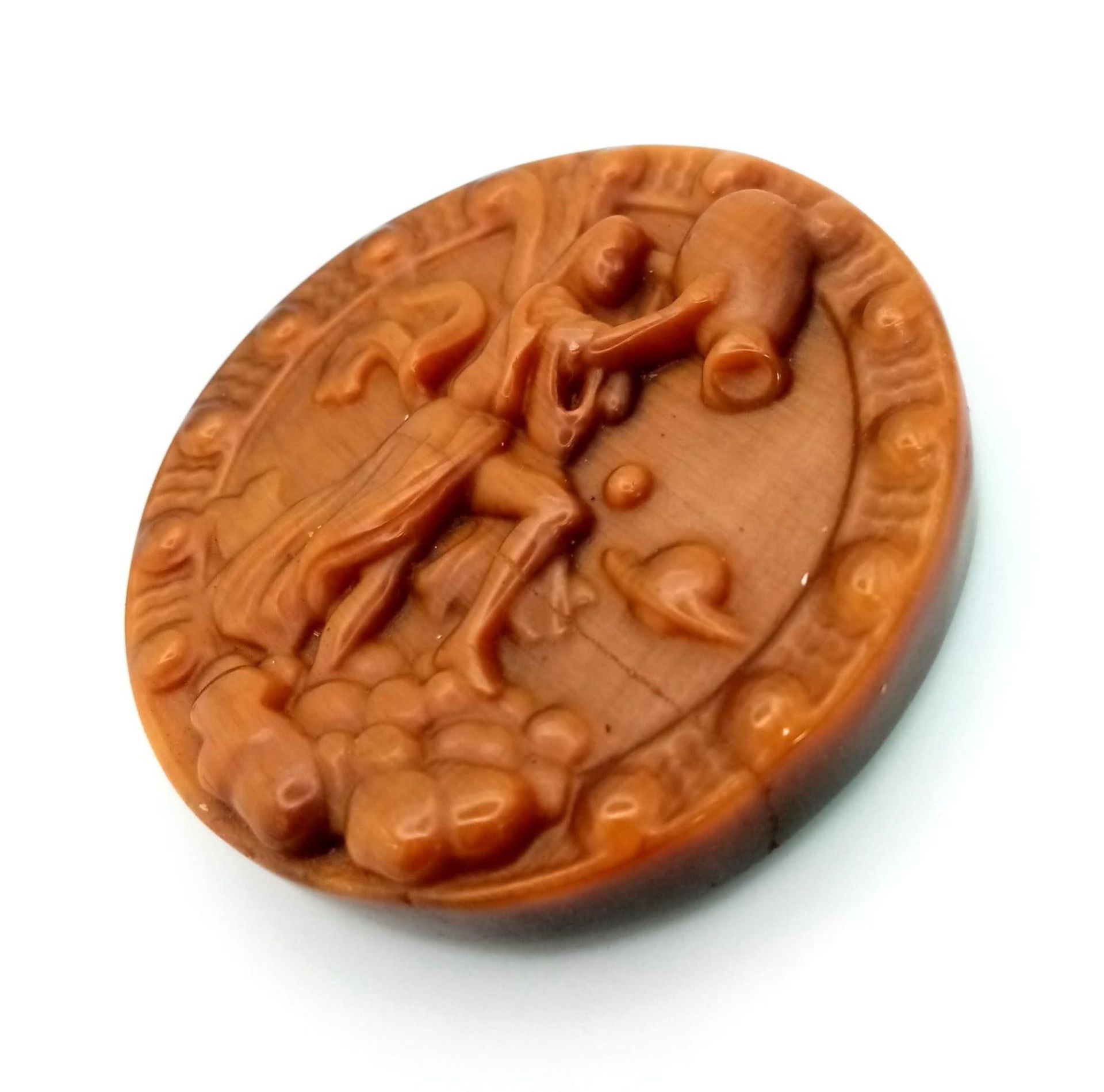 A Tigers Eye Carved Aquarian Design Healing Disc. 5cm diameter. - Image 2 of 2