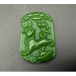 A Chinese Green Jade Foo Dog Pendant. 4 x 3cm