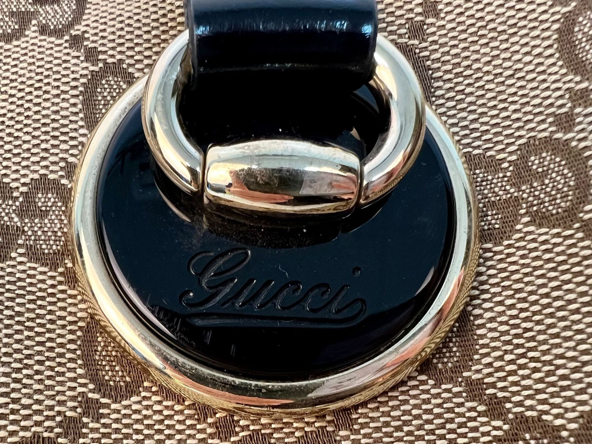 A Gucci Abbey Handbag. Monogram beige cotton exterior with black leather trim. Gucci logo black disc - Image 5 of 7