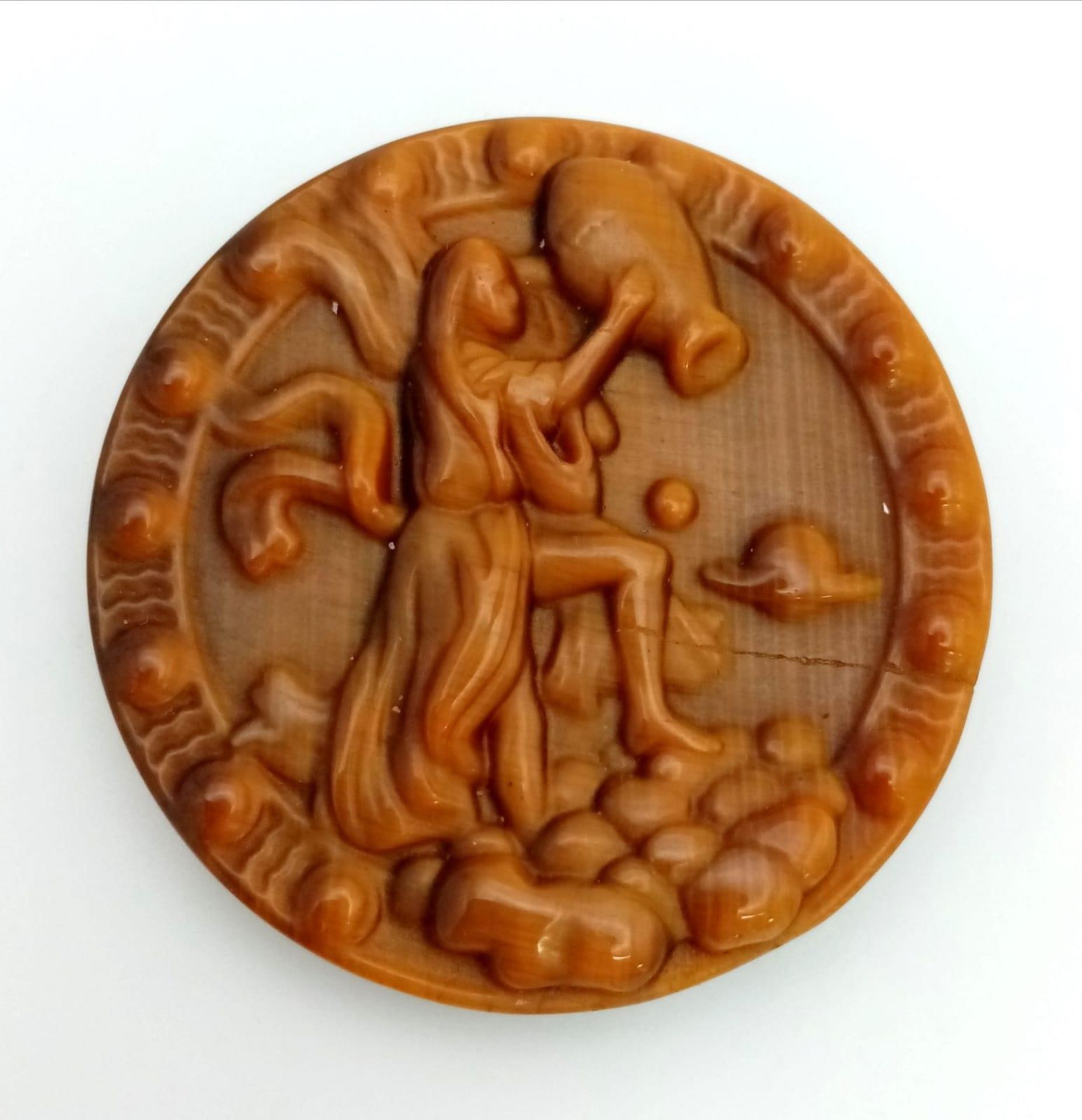 A Tigers Eye Carved Aquarian Design Healing Disc. 5cm diameter.