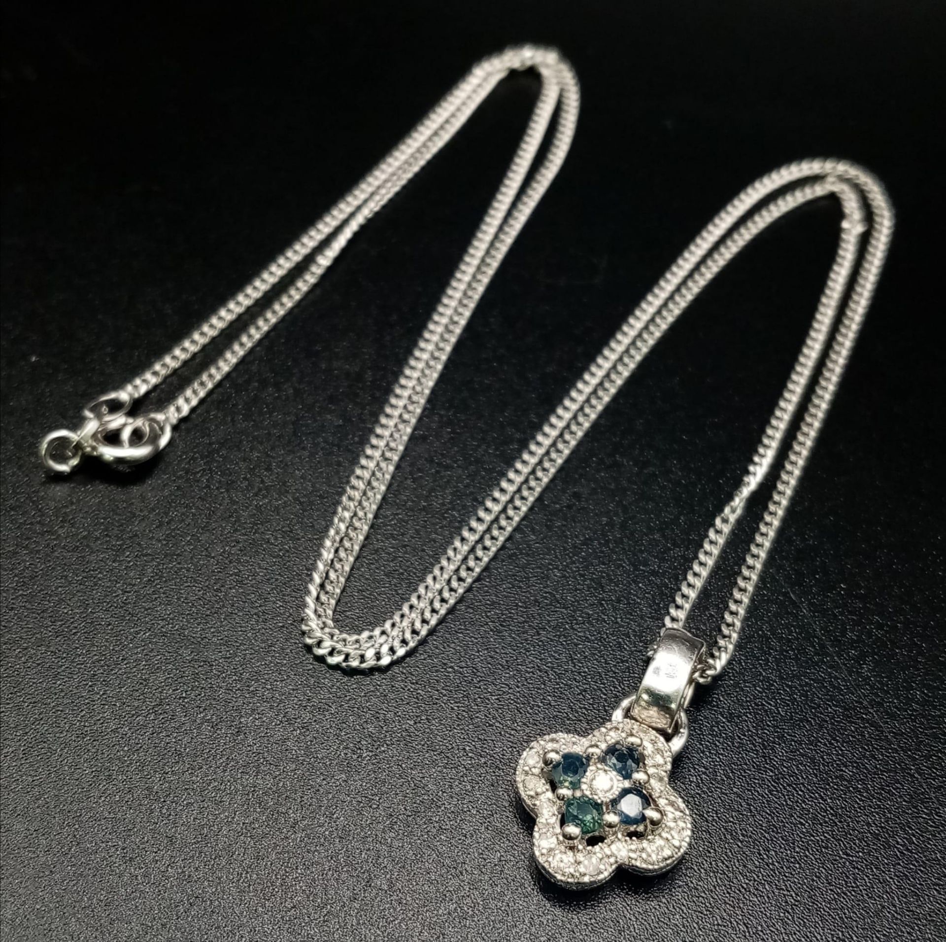 A 14K White Gold Sapphire and Diamond Pendant on a 9K White gold necklace. 15mm - pendant. 50cm