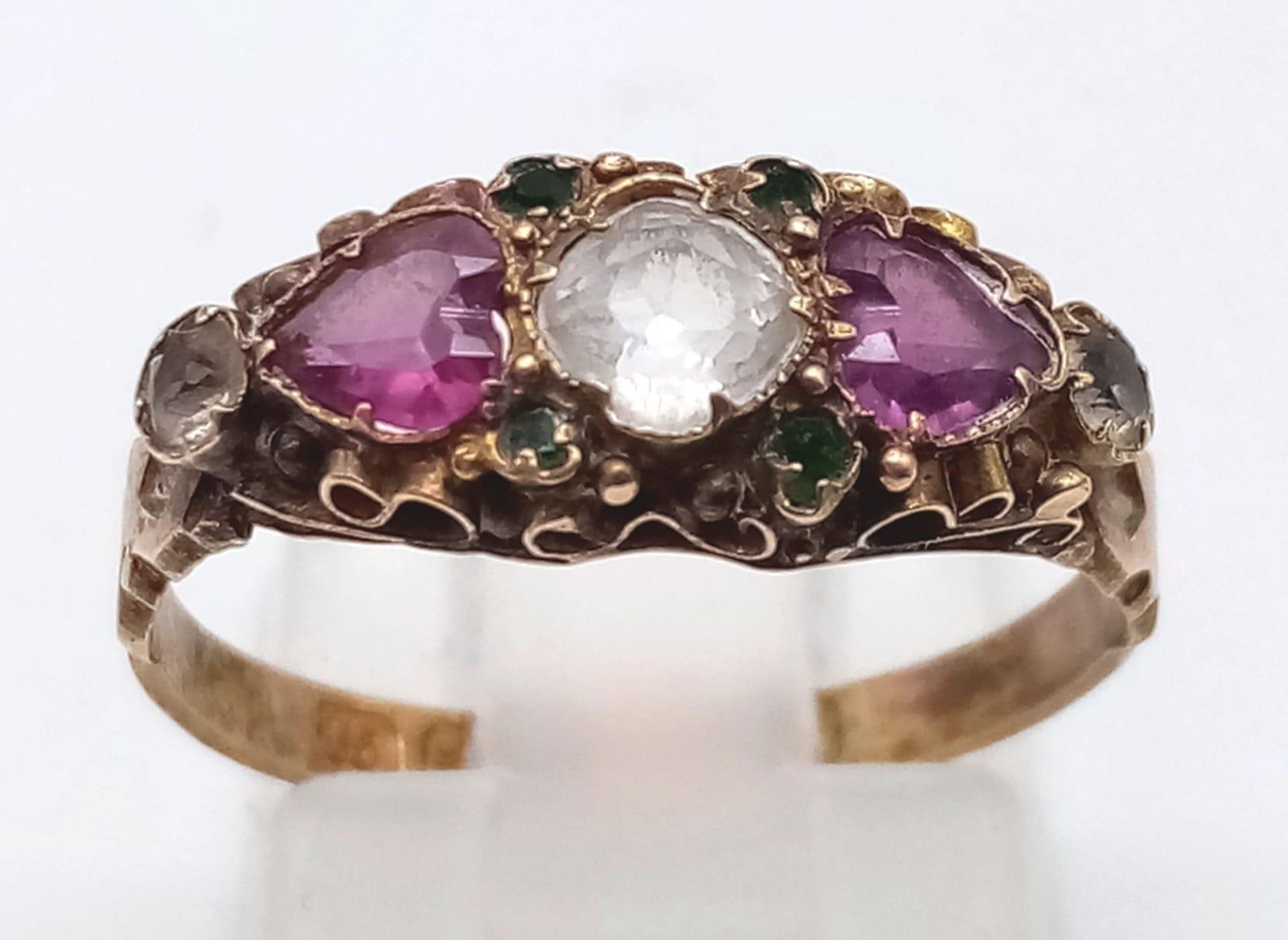 AN ANTIQUE 15K GOLD RING WITH A WHITE SAPPHIRE CENTRE STONE FLANKED BY AMETHYST AND DIAMONDS . 1.