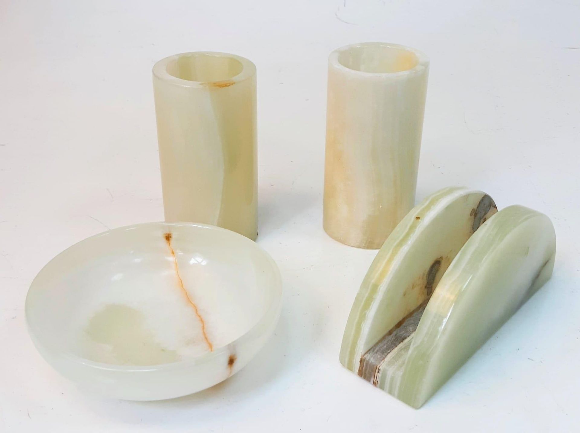 A Selection of Green Onyx Items: Two candle holders -10cm, letter-rack - 12cm and a small bowl -
