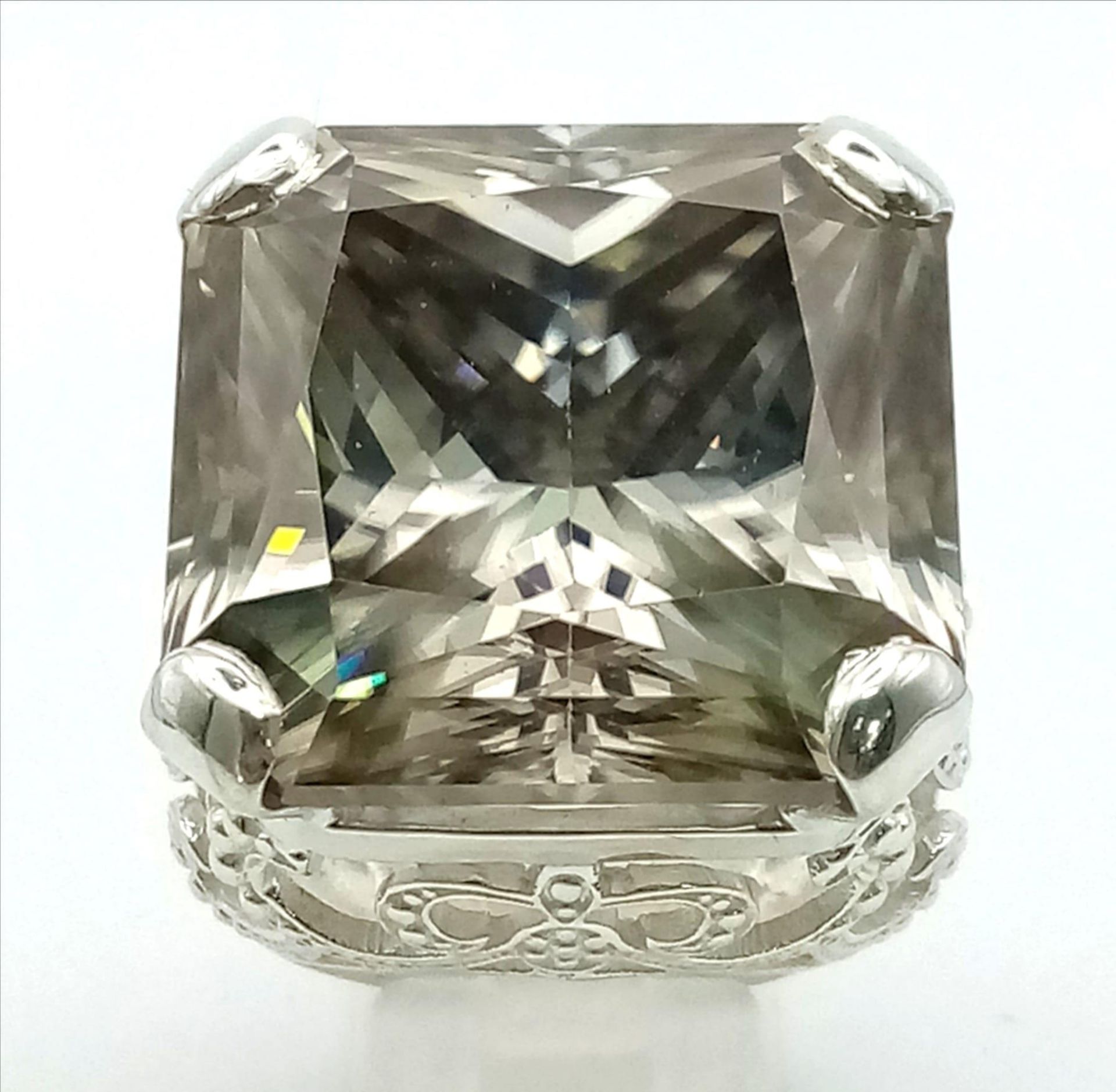 A Rare 79.4ct Brandy Shade Moissanite Ring set in 925 Silver. Size S. 31g total weight.