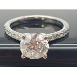 A FABULOUS 2.01ct DIAMOND RING SET IN PLATINUM WITH DIAMOND SHOULDERS . 5.3gms size N