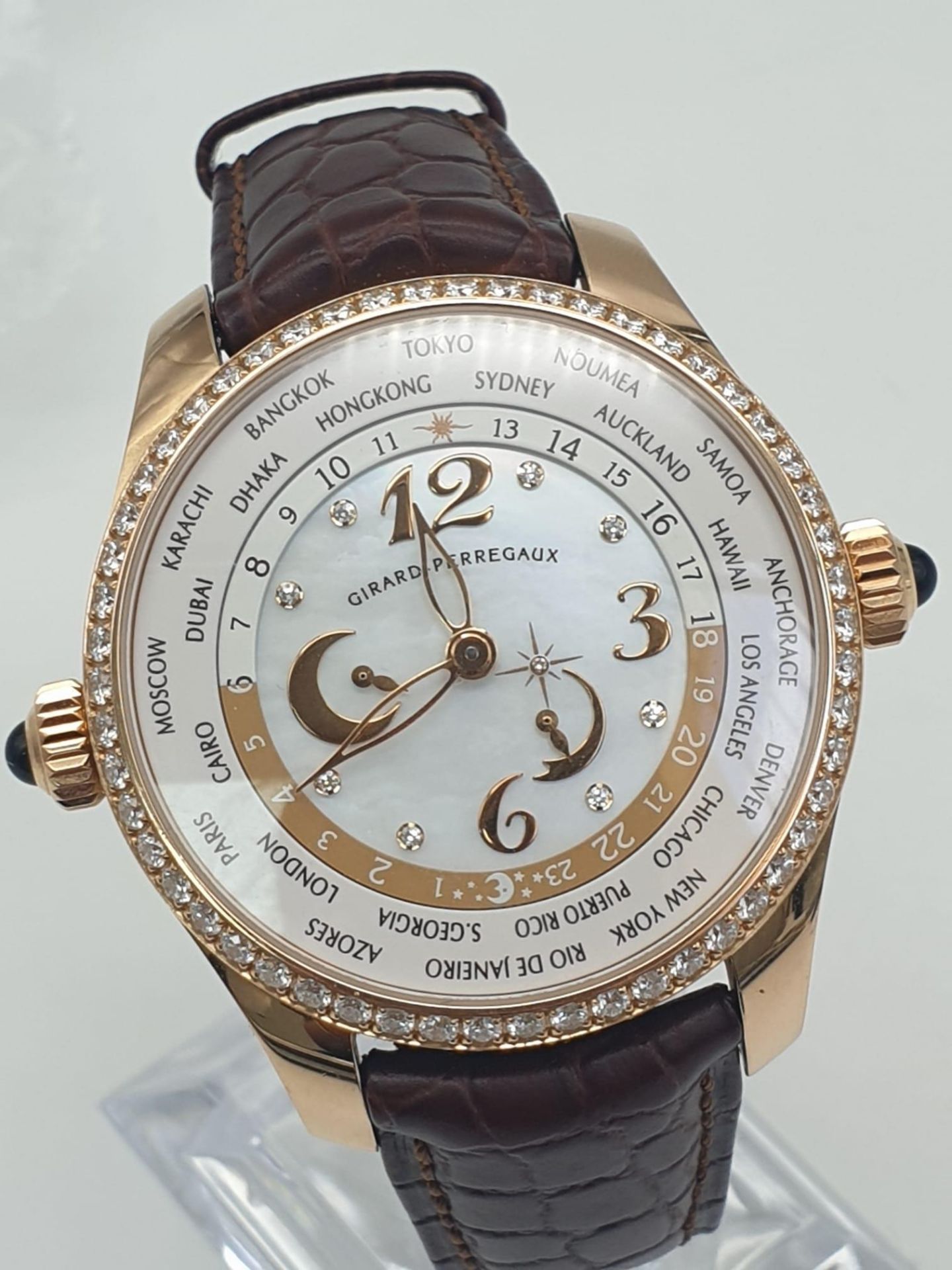 A Girard-Perregaux Financial World Time 18K Rose Gold Gents Watch. Brown leather strap with 18k rose