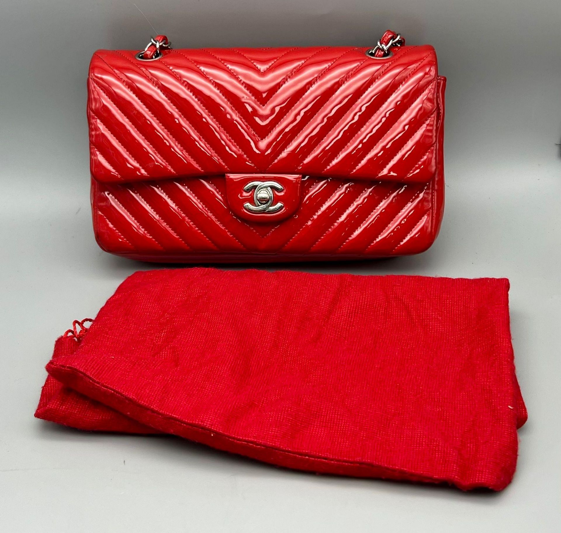 A Chanel Patent Leather Flap Handbag. Bright red patent leather quilted exterior. Classic Chanel - Image 7 of 7