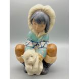 A Vintage Lladro Eskimo with Polar Bear Cub Ceramic Figure. 21cm tall.