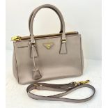 A Prada Saffiano Galleria Handbag with Shoulder Strap. Luxurious grey leather exterior. Three