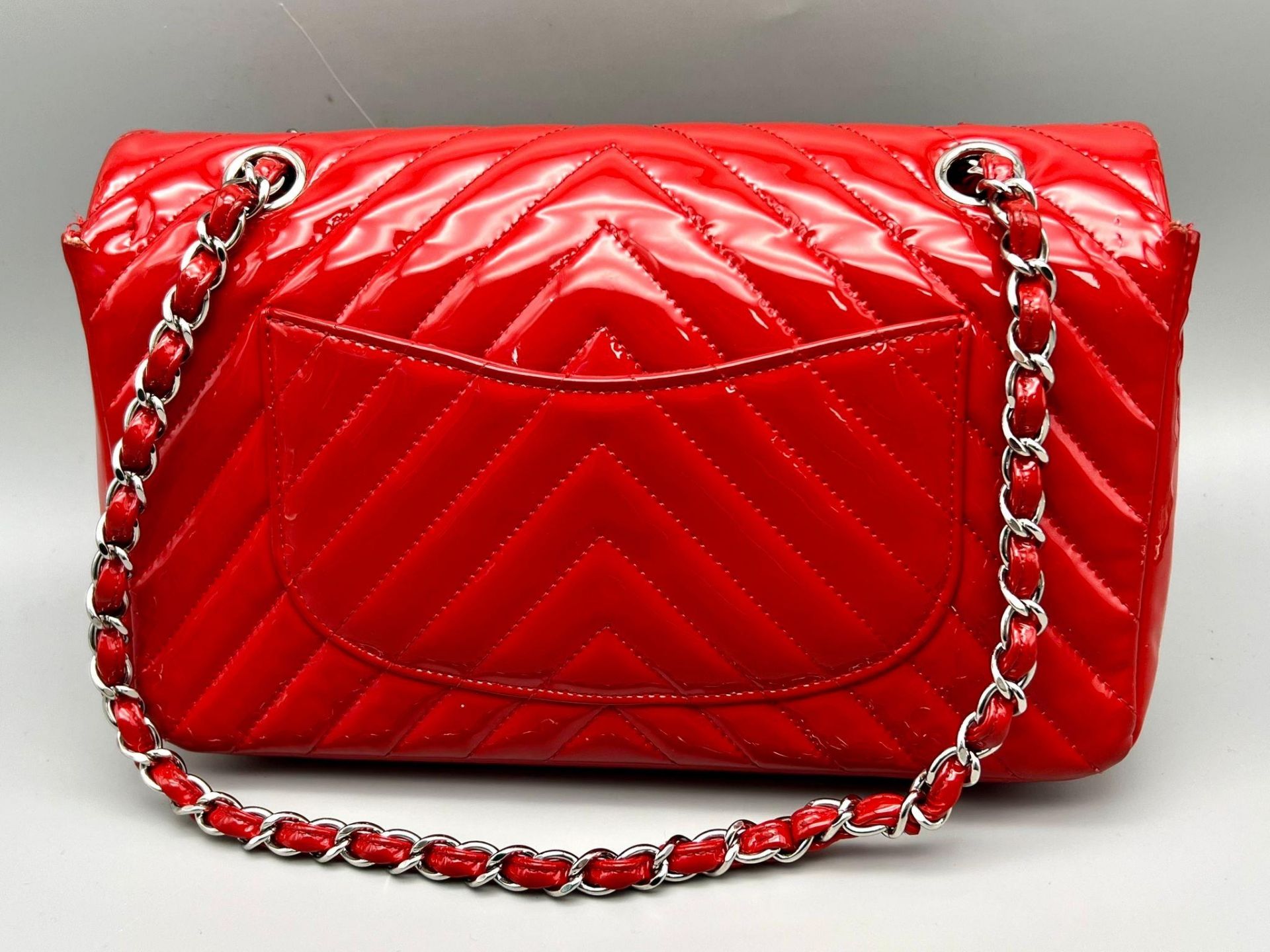 A Chanel Patent Leather Flap Handbag. Bright red patent leather quilted exterior. Classic Chanel - Image 3 of 7