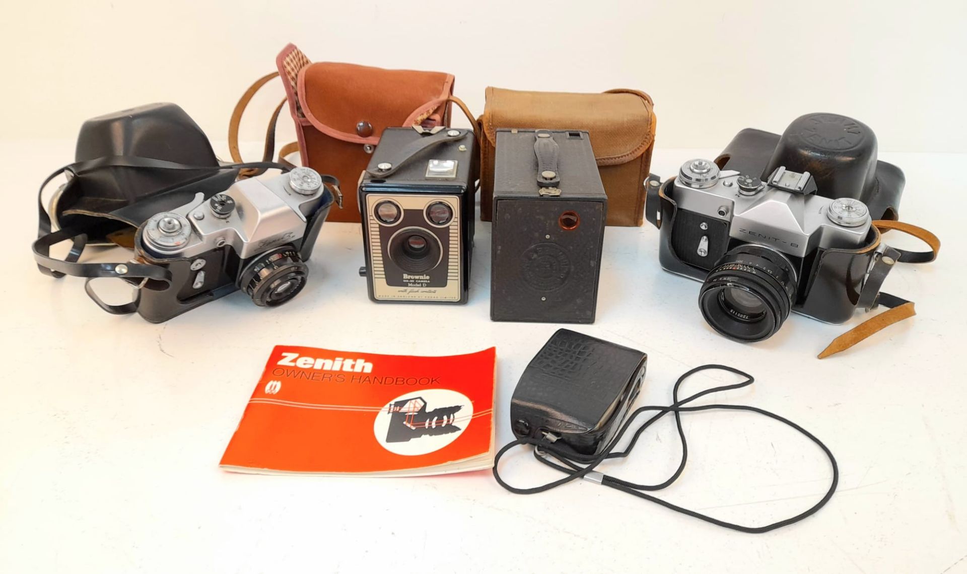 A Selection of Four Vintage Cameras and a Light Meter.