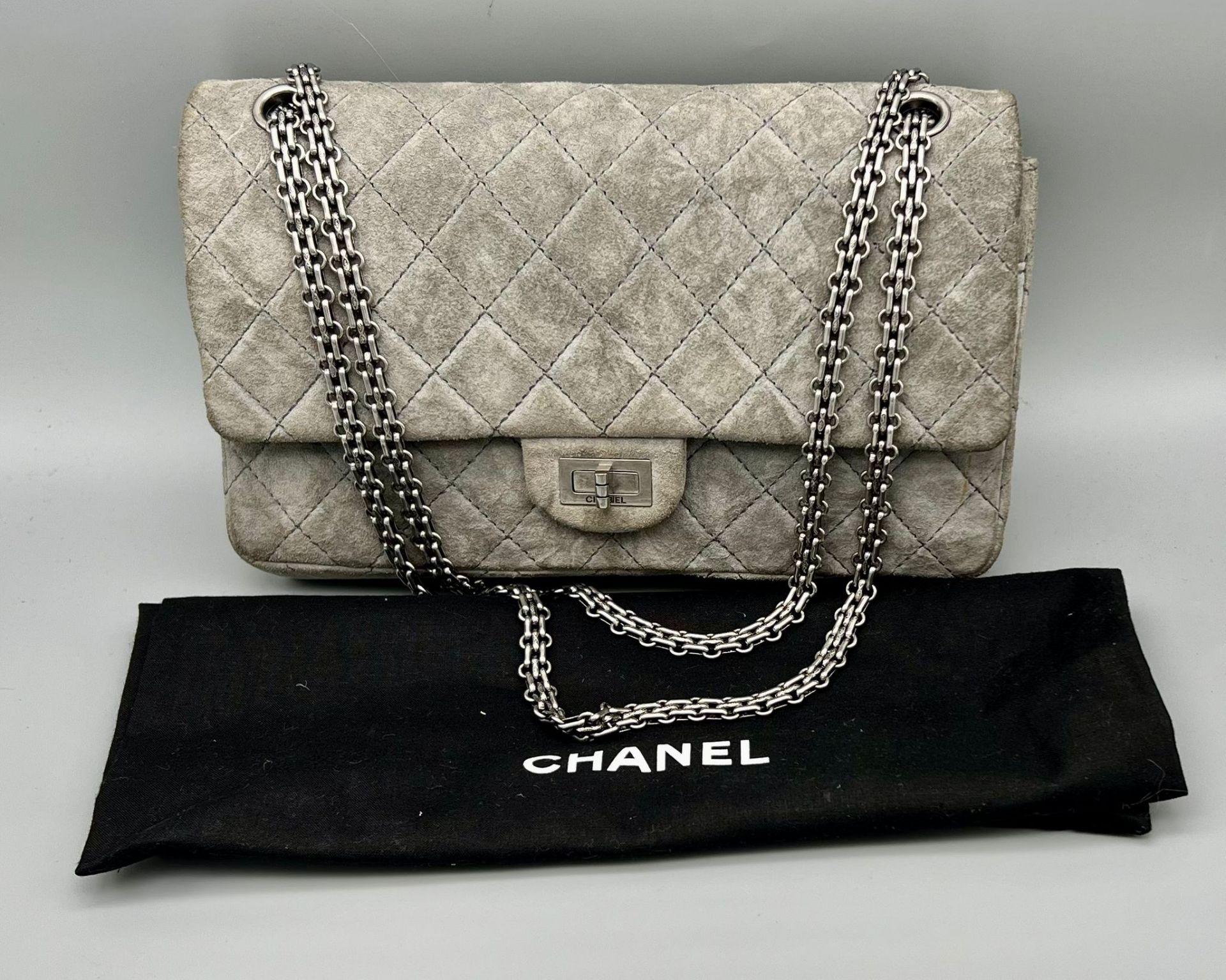 A Classic Chanel Grey Suede Quilted Large Shoulder Flap Bag. Quilted soft suede exterior (worn).