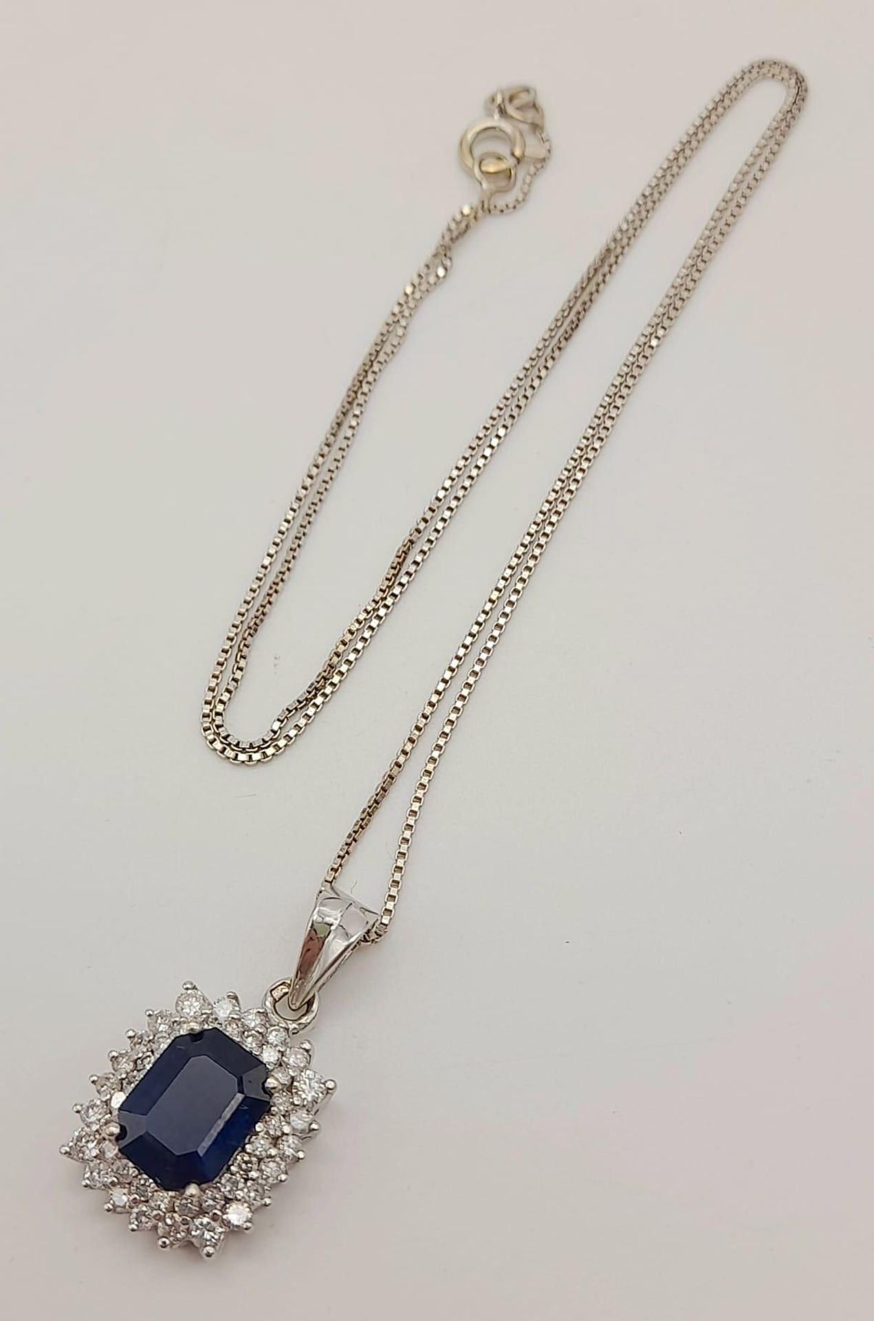 An 18K White Gold, Sapphire and Diamond Pendant on an 18K White Gold Necklace. Rectangular 2ct