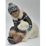 A Large Vintage Lladro Eskimo Boy and Polar Bear Cub Figure. Good condition. 28cm x 25cm.