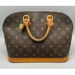 A Louis Vuitton Alma Monogram Canvas Bag. Brown leather handles with gilded lock and key. Brown