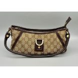 A Gucci Monogram Canvas Baguette Pouch Bag. Leather handle and trim. Gold-tone hardware. Brown