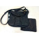 A Gucci Black Python/Snakeskin Shoulder Bag. Gold-tone hardware. Adjustable shoulder strap. Spacious