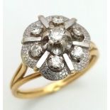 A Vintage 18K Yellow Gold and Diamond Floral Ring. Central petal-cut diamond surrounded by a halo of