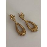 PAIR of 9 carat GOLD EARRINGS in drop style with attractive Fleur de Lys detail. Complete with 9