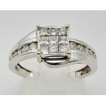 An 18K White Gold and Princess Cut Diamond Ring. Nine small princess cut diamonds with seven