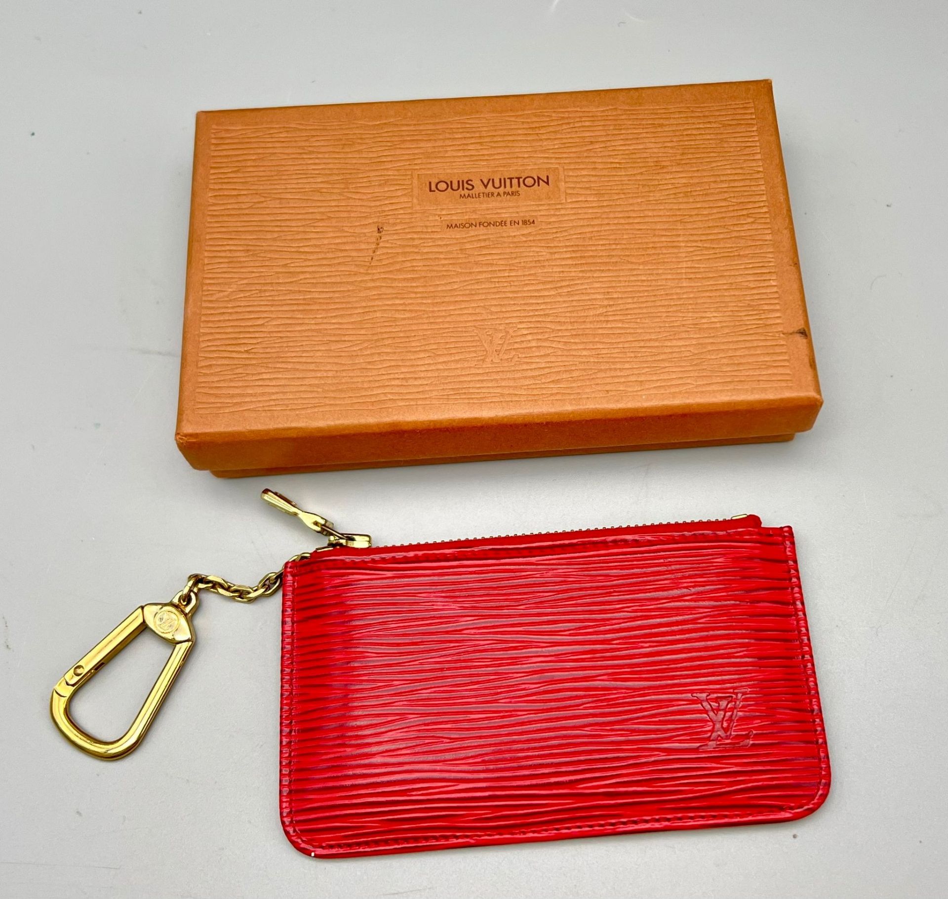 A Louis Vuitton Small Red Textured Epi Leather Key Pouch. As new, in original LV packaging. 12cm x