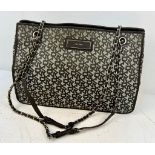 A DKNY Monogram Canvas Shoulder Bag with Dust-Cover. Spacious interior with zipped and open