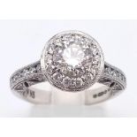 A STUNNING 18K WHITE GOLD DIAMOND RING WITH A BRIGHT CLEAR .8ct CENTRE STONE SURROUNDED BY A HALO OF