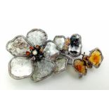 A SHOW STOPPING DIAMOND BROOCH IN THE FORM OF FLOWERS AND A BUTTERFLY . 32.1gms 9cms in height.