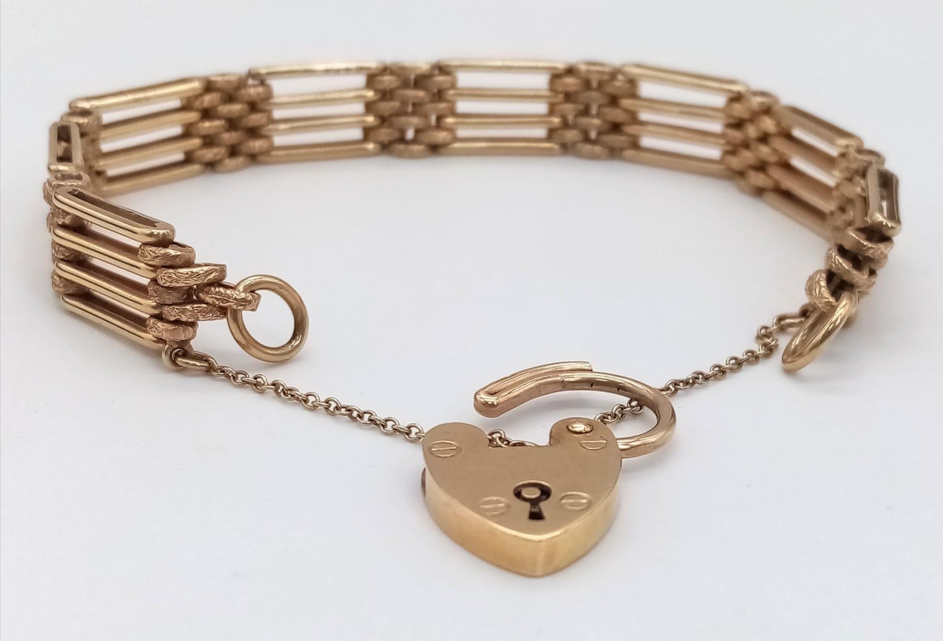 A Lovely Vintage 9K Yellow Gold Gate Bracelet with Heart Clasp. 18cm. 27.6g. Comes in a presentation