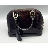 A Louis Vuitton Burgundy Patent Leather Handbag. Monogram LV patent leather, gold-tone hardware.