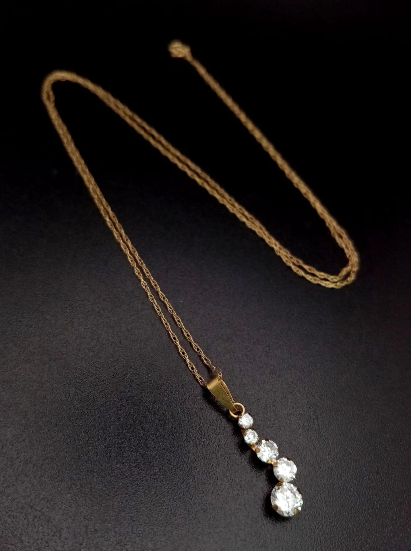 A 9K Yellow Gold White Stone Pendant on a 9K Yellow Gold Disappearing Necklace. 20mm and 44cm. 0.72g